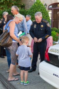 Police officer interacting with mother and child