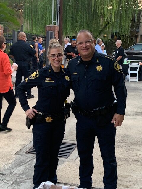 Two law enforcers smiling at the camera