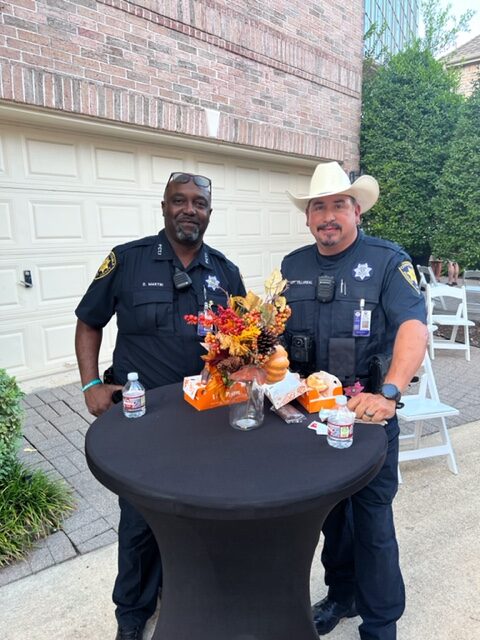 Two Officers standing at the table with some food