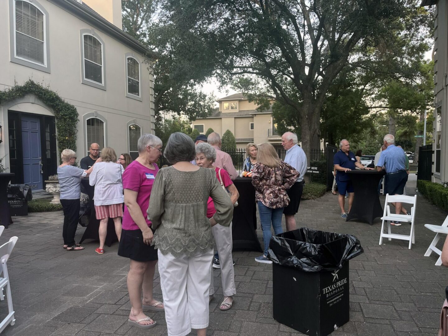 People socializing at outdoor courtyard gathering