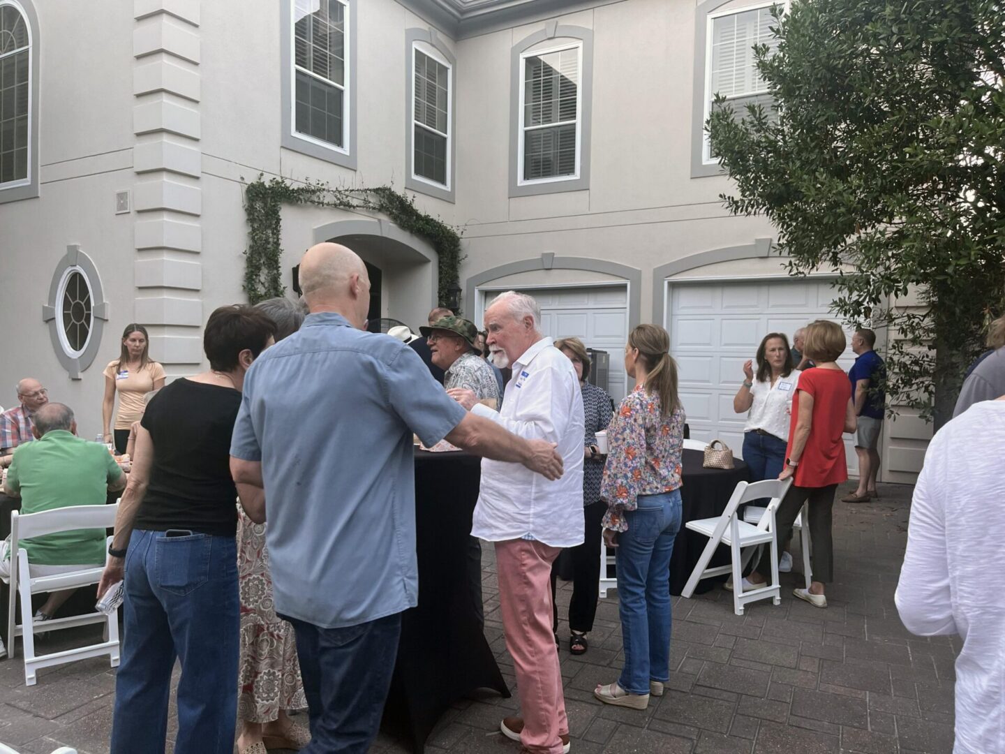 Group of people socializing outside a house